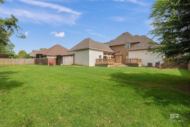 back of house with a yard and a deck