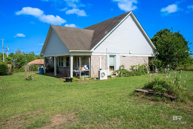 48851 Colt Run, Bay Minette, AL 36507 - back of property with brick siding, a lawn, and a cooling unit