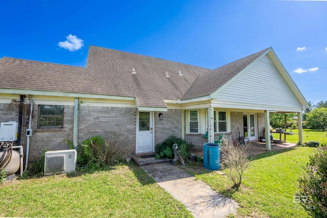 48851 Colt Run, Bay Minette, AL 36507 - back of house with brick siding, a lawn, ac unit, and a shingled roof