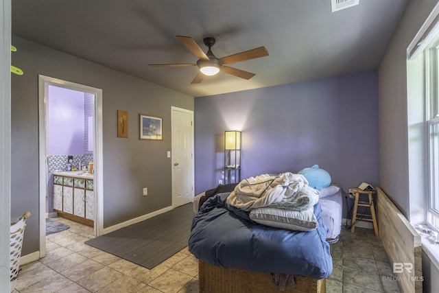 48851 Colt Run, Bay Minette, AL 36507 - tiled bedroom featuring multiple windows, connected bathroom, ceiling fan, and baseboards