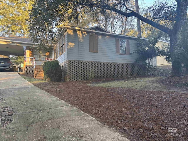 view of home's exterior featuring a carport