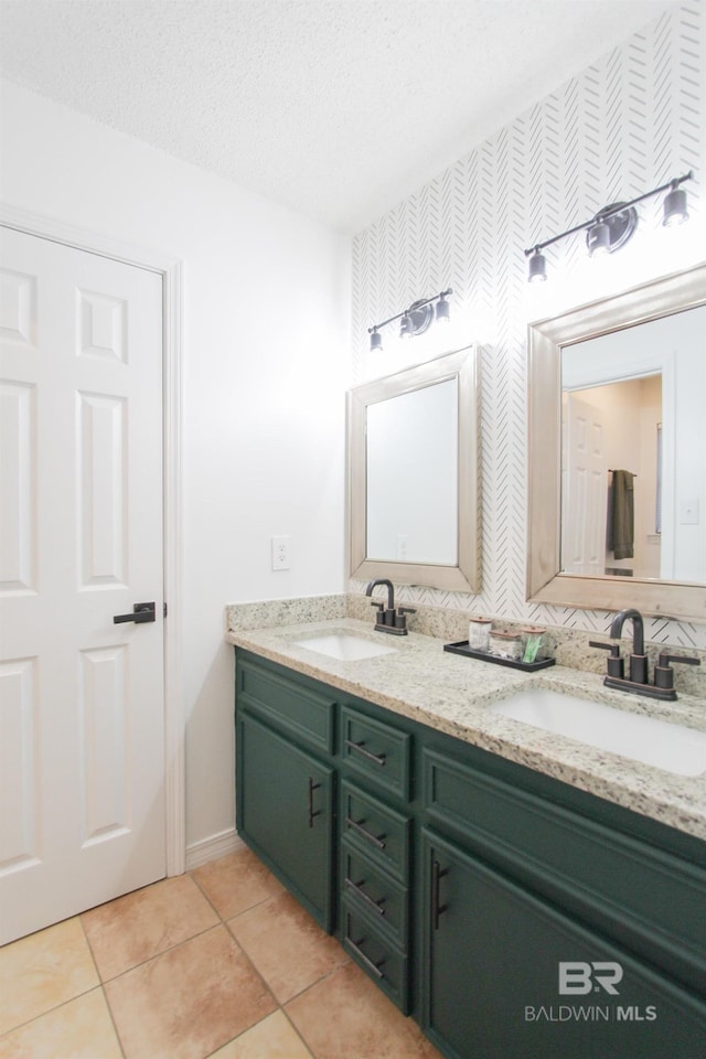 bathroom featuring tile patterned floors, vanity, and a textured ceiling