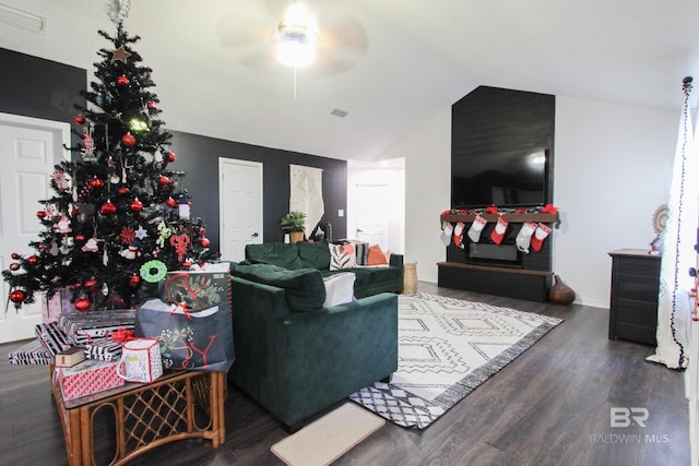 living room with vaulted ceiling, ceiling fan, and dark wood-type flooring