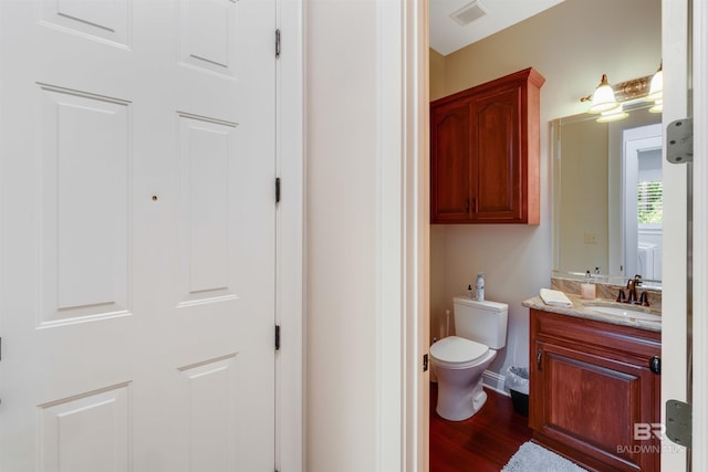 bathroom featuring vanity, toilet, and wood-type flooring