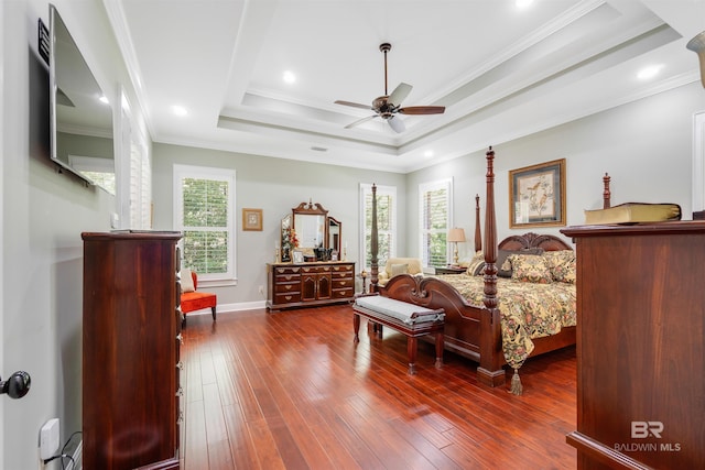 bedroom with a tray ceiling, ceiling fan, dark hardwood / wood-style floors, and ornamental molding