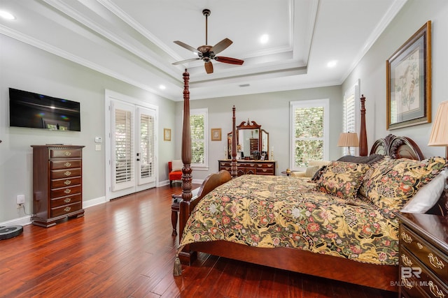 bedroom with a raised ceiling, dark hardwood / wood-style floors, access to outside, ornamental molding, and ceiling fan