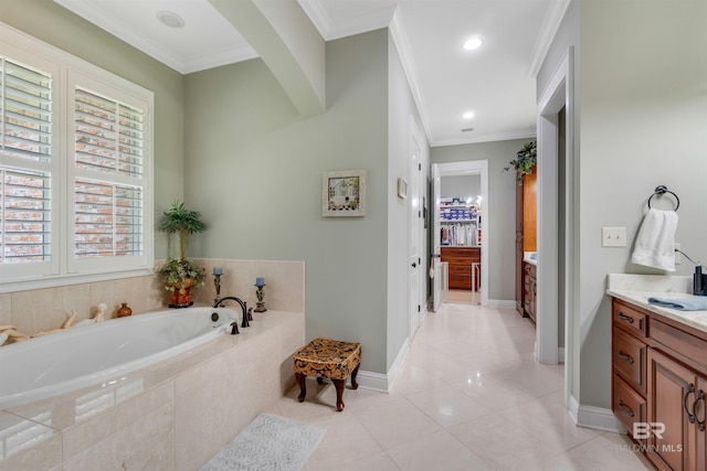 bathroom with ornamental molding, vanity, a relaxing tiled tub, and tile patterned floors