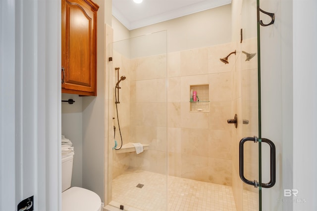 bathroom with ornamental molding, toilet, and an enclosed shower