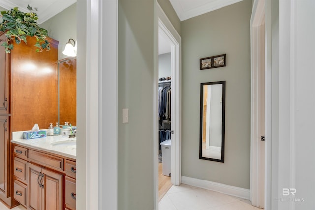 bathroom with tile patterned flooring, vanity, and crown molding