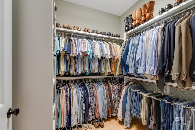 walk in closet with light hardwood / wood-style flooring