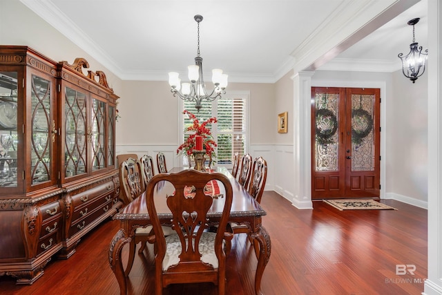 dining space featuring ornamental molding, a chandelier, dark hardwood / wood-style flooring, and ornate columns