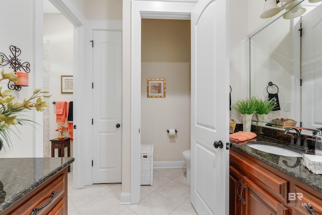 bathroom with tile patterned floors, toilet, and vanity