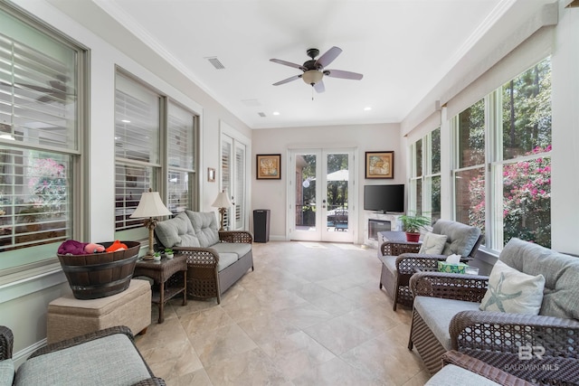 sunroom with plenty of natural light, ceiling fan, and french doors