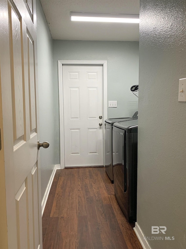 laundry area with baseboards, laundry area, dark wood finished floors, and independent washer and dryer