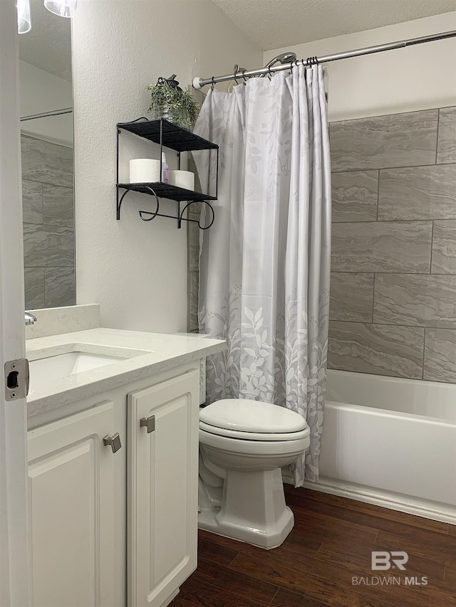 bathroom featuring vanity, toilet, wood finished floors, and shower / tub combo