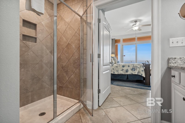 25494 Perdido Beach Blvd Unit 2005, Orange Beach, AL 36561 - ensuite bathroom featuring ensuite bathroom, tile patterned floors, ceiling fan, and a stall shower