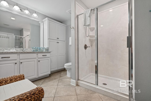 25494 Perdido Beach Blvd Unit 2005, Orange Beach, AL 36561 - bathroom with tile patterned flooring, vanity, toilet, a shower stall, and visible vents