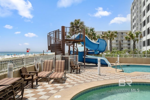 25494 Perdido Beach Blvd Unit 2005, Orange Beach, AL 36561 - community pool featuring fence, stairs, a patio area, a water view, and a water slide