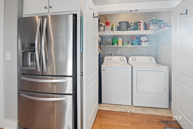 5781 State Highway 180 Unit 6020, Gulf Shores, AL 36542 - washroom with light hardwood / wood-style floors and washing machine and dryer