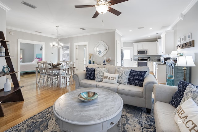 5781 State Highway 180 Unit 6020, Gulf Shores, AL 36542 - living room with crown molding, light hardwood / wood-style flooring, and plenty of natural light