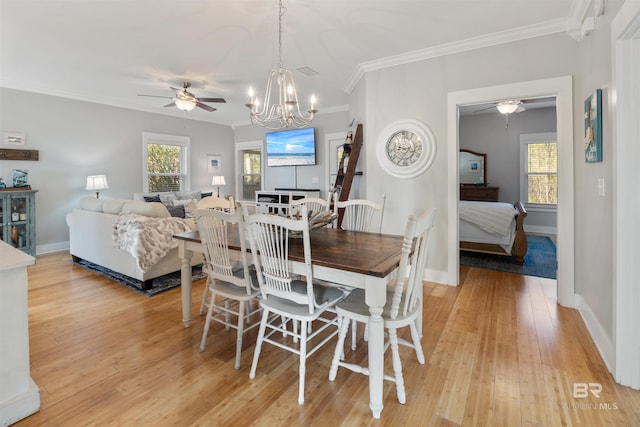 5781 State Highway 180 Unit 6020, Gulf Shores, AL 36542 - dining area featuring crown molding, a healthy amount of sunlight, and light hardwood / wood-style floors