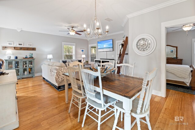 5781 State Highway 180 Unit 6020, Gulf Shores, AL 36542 - dining space featuring crown molding, ceiling fan with notable chandelier, and light hardwood / wood-style flooring
