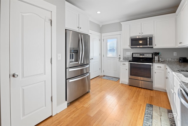 5781 State Highway 180 Unit 6020, Gulf Shores, AL 36542 - kitchen with light stone counters, light hardwood / wood-style flooring, ornamental molding, appliances with stainless steel finishes, and white cabinets
