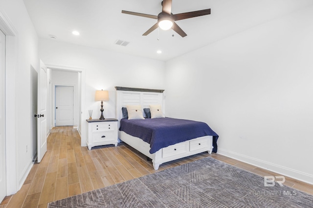 bedroom with ceiling fan and light wood-type flooring