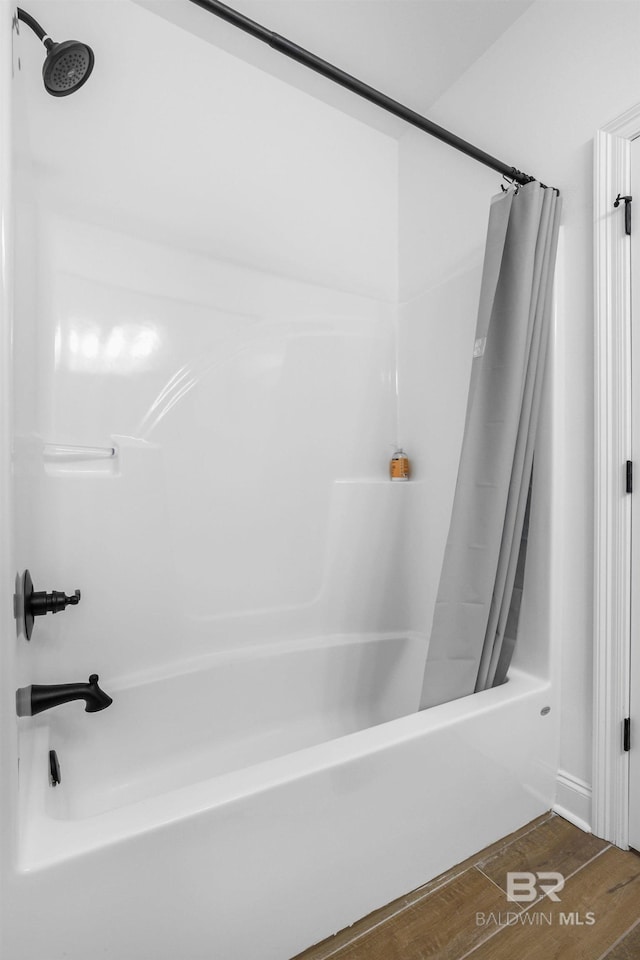 bathroom with shower / tub combo with curtain