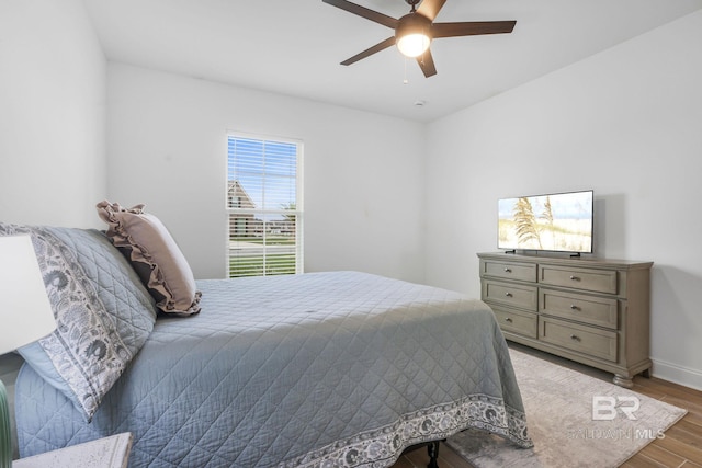 bedroom with ceiling fan and wood-type flooring