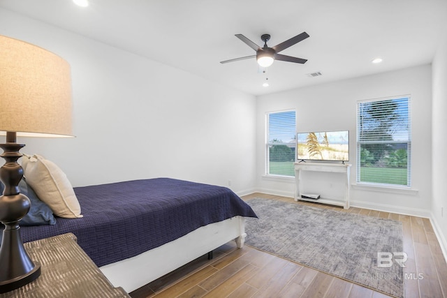 bedroom with hardwood / wood-style floors and ceiling fan