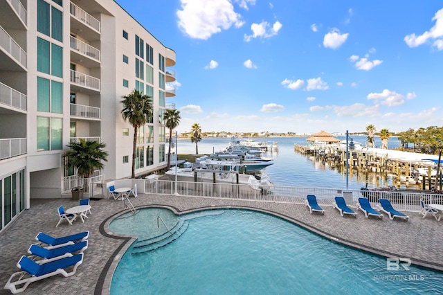 view of swimming pool with a water view