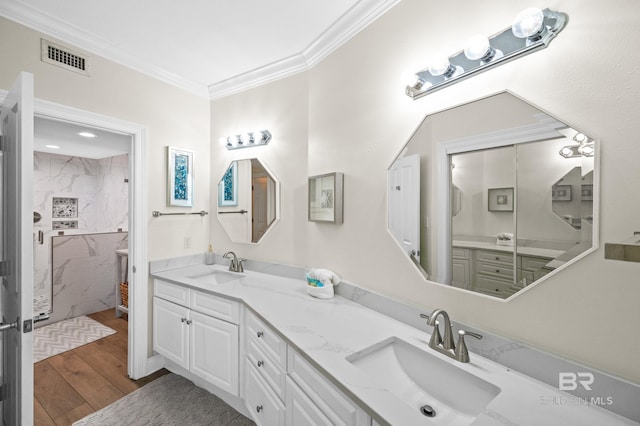 bathroom with vanity, hardwood / wood-style flooring, a shower, and crown molding