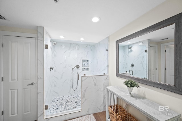 bathroom featuring vanity, hardwood / wood-style flooring, and an enclosed shower