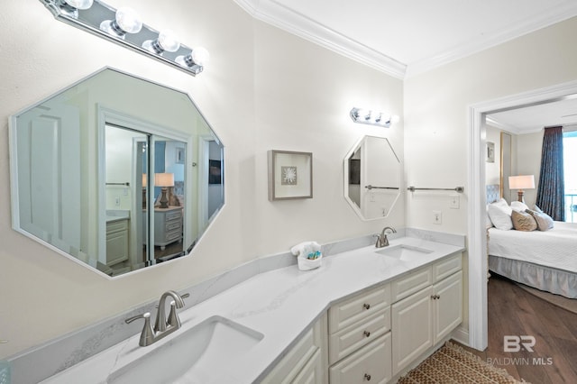 bathroom featuring wood-type flooring, vanity, and crown molding