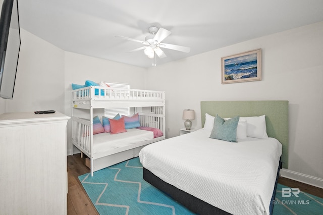 bedroom with ceiling fan and dark hardwood / wood-style flooring