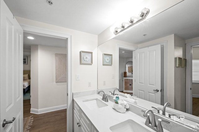 bathroom with hardwood / wood-style floors and vanity