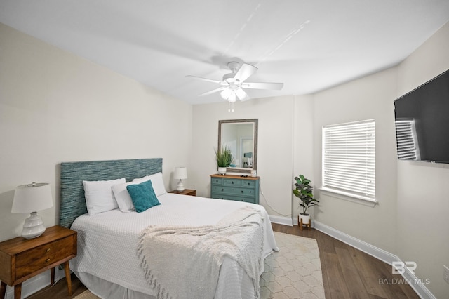 bedroom with ceiling fan and dark hardwood / wood-style floors