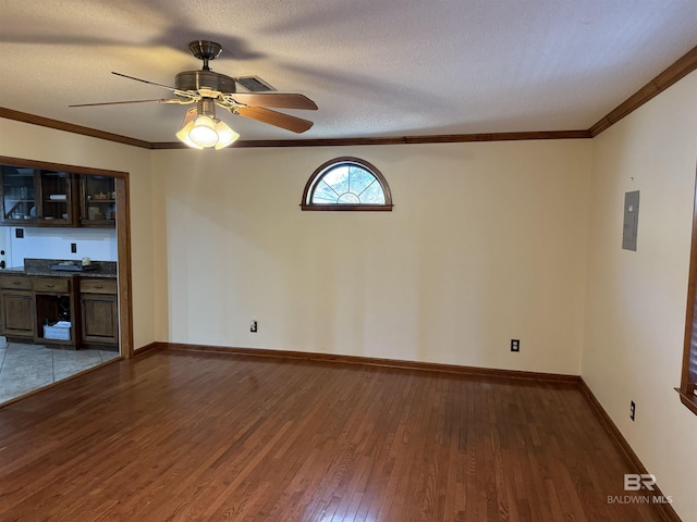 interior space with crown molding, dark wood-type flooring, and a textured ceiling