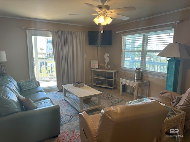 living room featuring ornamental molding, carpet floors, plenty of natural light, and ceiling fan