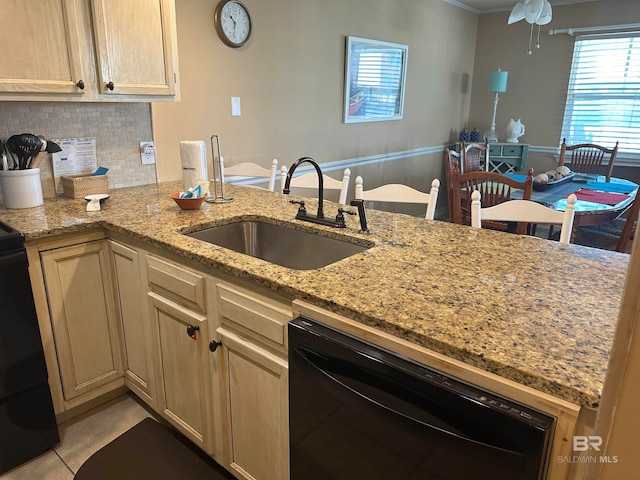 kitchen with dishwasher, kitchen peninsula, sink, light stone countertops, and ceiling fan