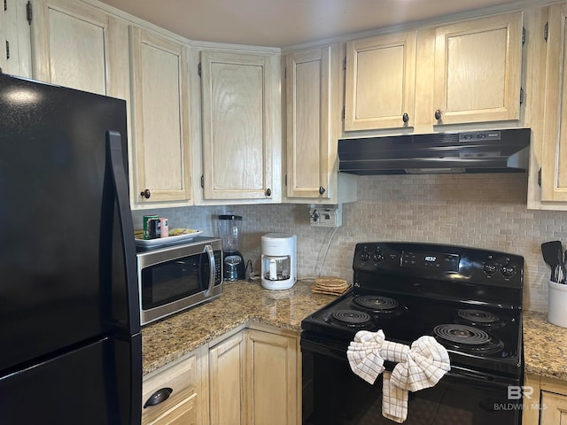 kitchen featuring light stone countertops, black appliances, and backsplash