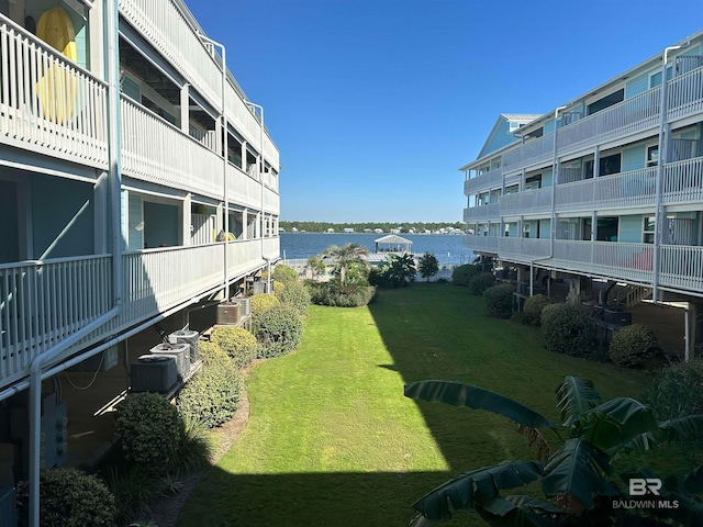 view of home's community featuring a water view and a yard