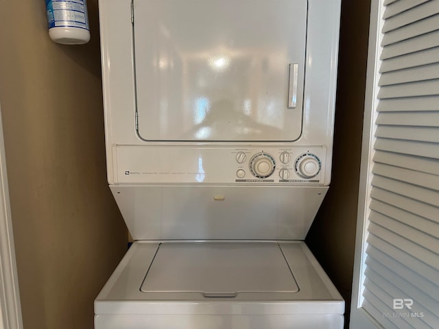 laundry room with stacked washer / drying machine