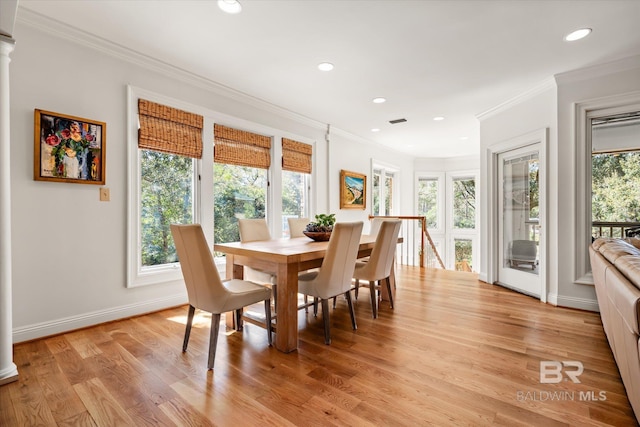 dining room featuring crown molding, baseboards, decorative columns, recessed lighting, and light wood-style flooring