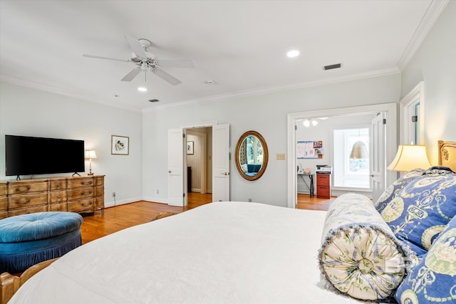 bedroom featuring visible vents, baseboards, ornamental molding, recessed lighting, and wood finished floors