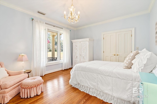 bedroom with visible vents, a closet, wood finished floors, and crown molding