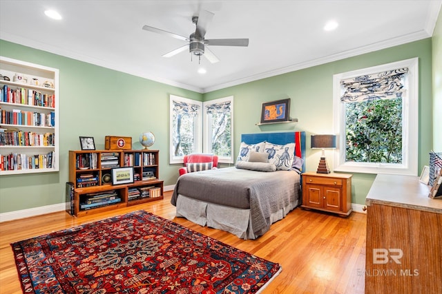 bedroom featuring light wood-style floors, baseboards, and ornamental molding