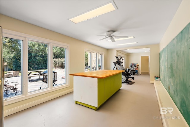 home office with baseboards and ceiling fan