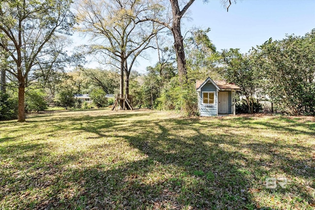 view of yard featuring a playground, a storage shed, and an outdoor structure